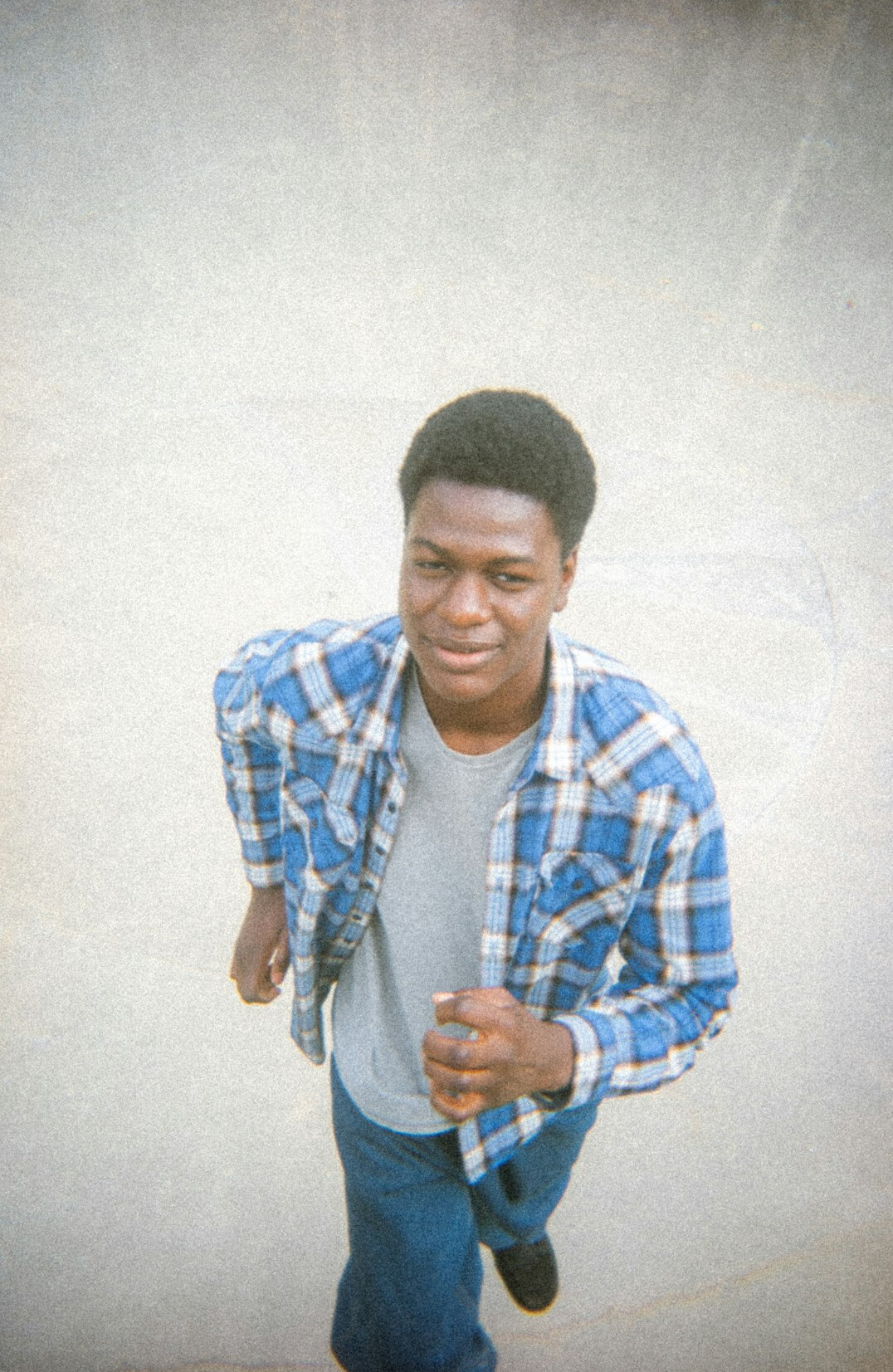 Portrait of a man with short hair and a friendly smile wearing a casual shirt