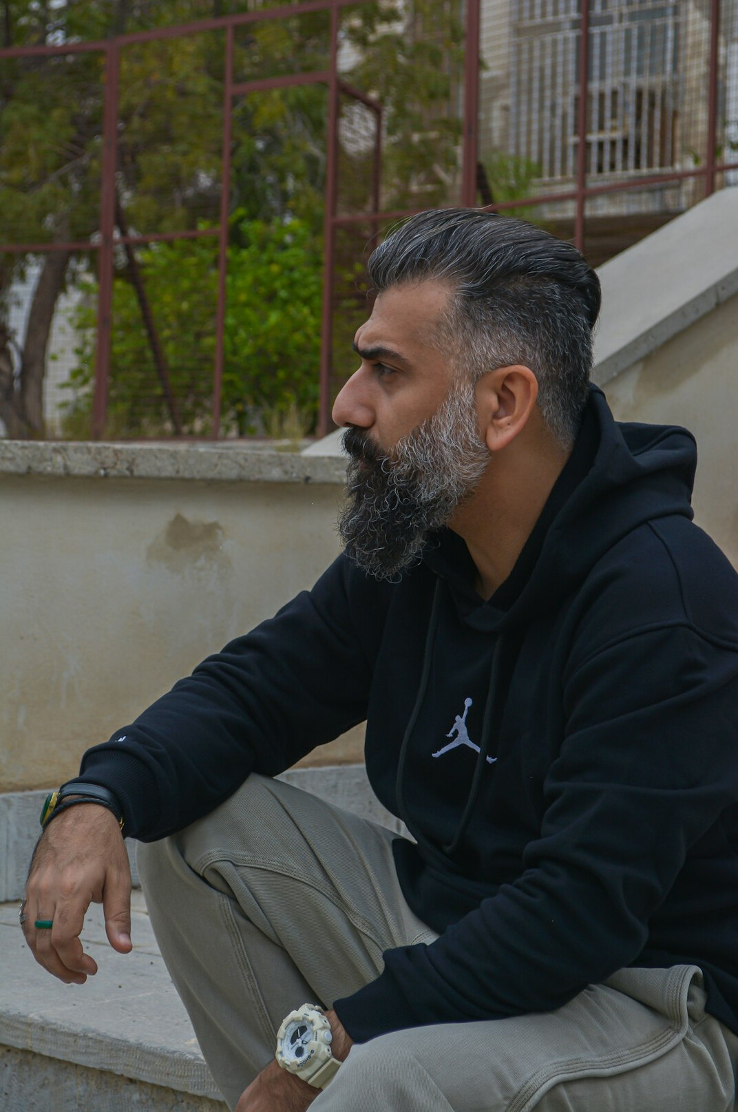 Portrait of a middle-aged man with a grey beard wearing a dark sweater