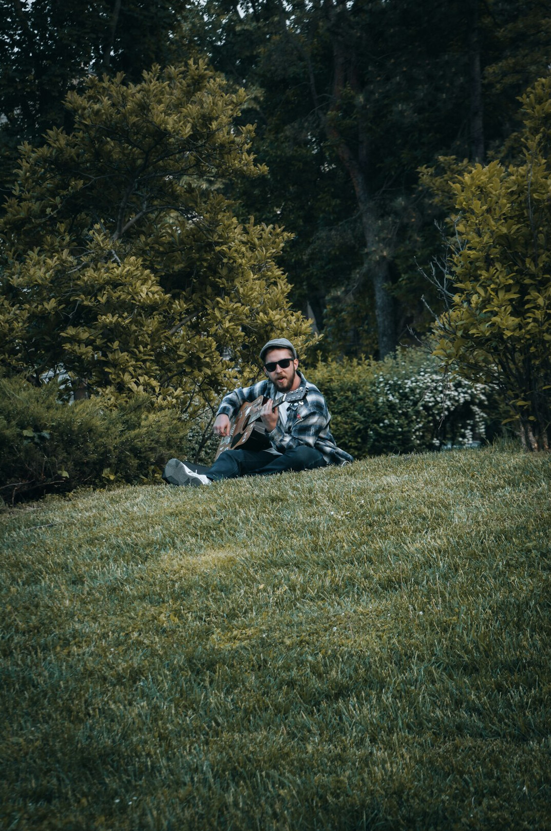 Smiling female instructor standing beside a broadcast control desk wearing a headset