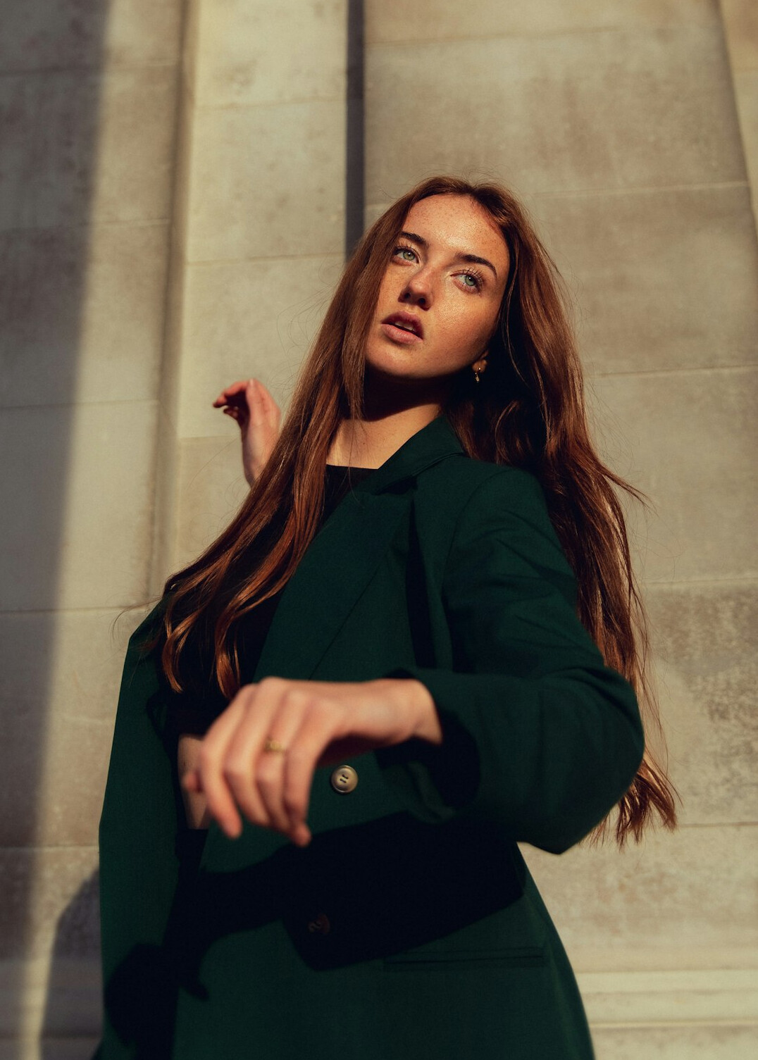 Portrait of a woman with long dark hair wearing a green blazer