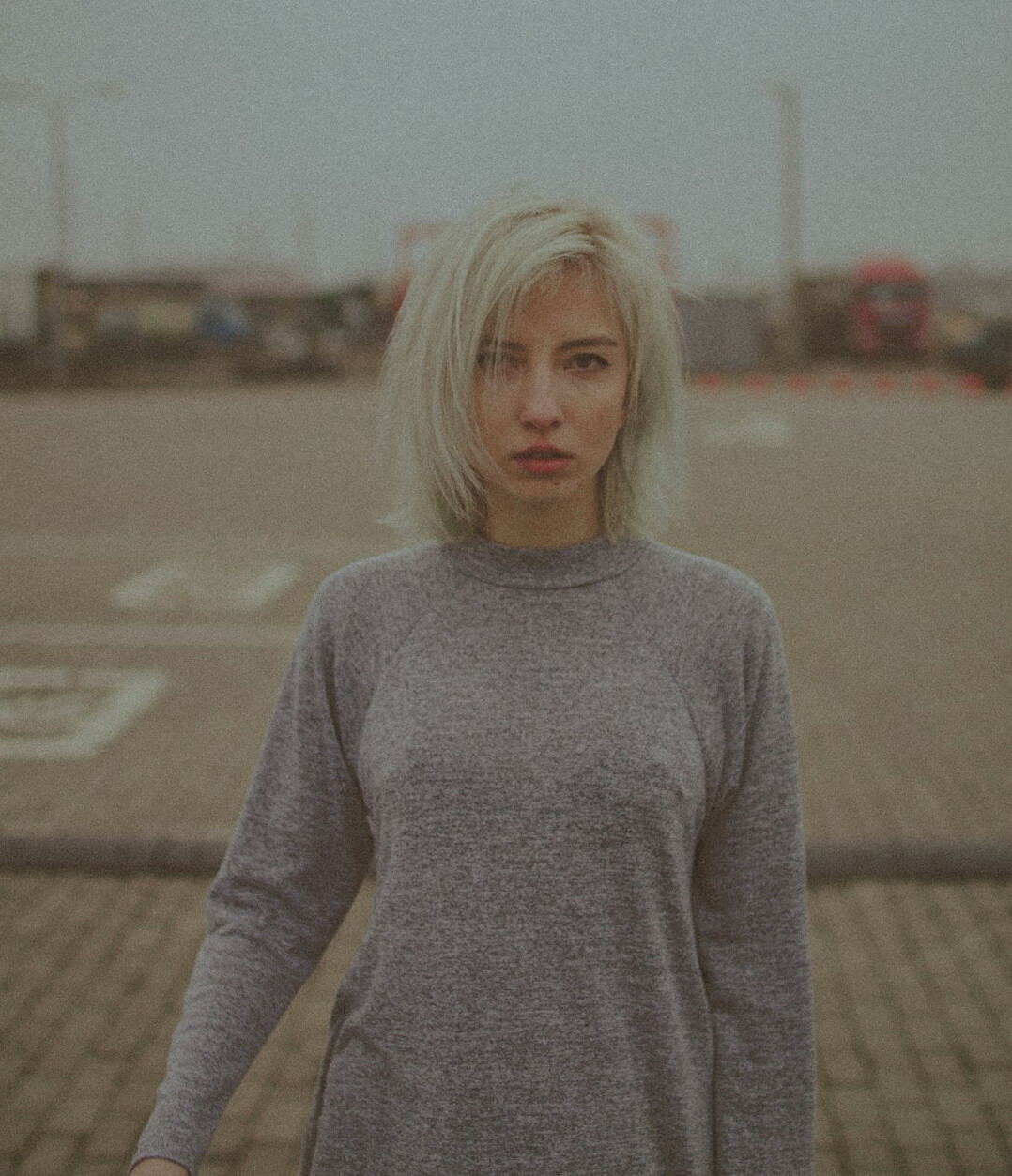 Portrait of a young woman with a bob haircut wearing a light sweater